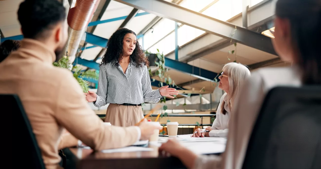 brainstorming, speaker and woman in boardroom, creative and brand specialist with ideas for project business, team and people with strategy for target audience, trends and speech for workshop